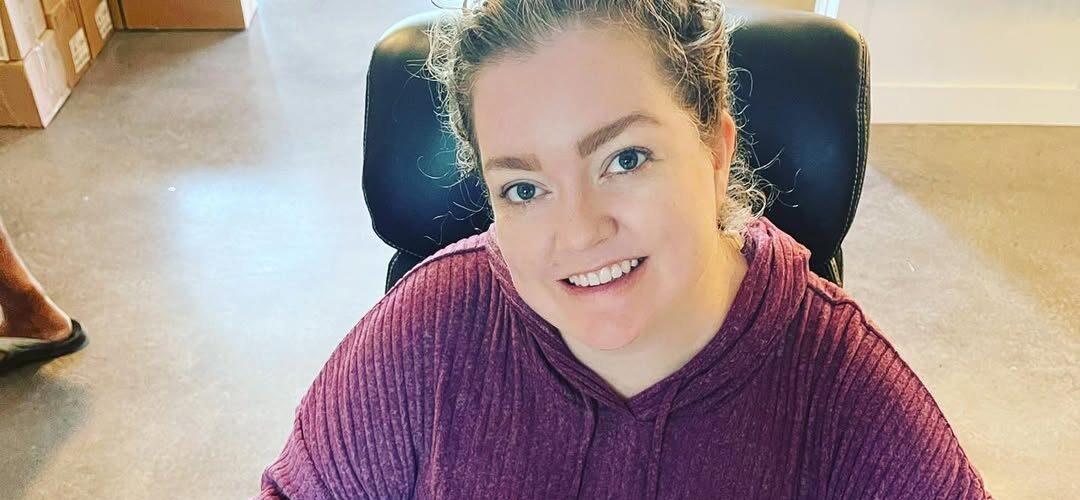 Colleen Hoover sitting in a chair