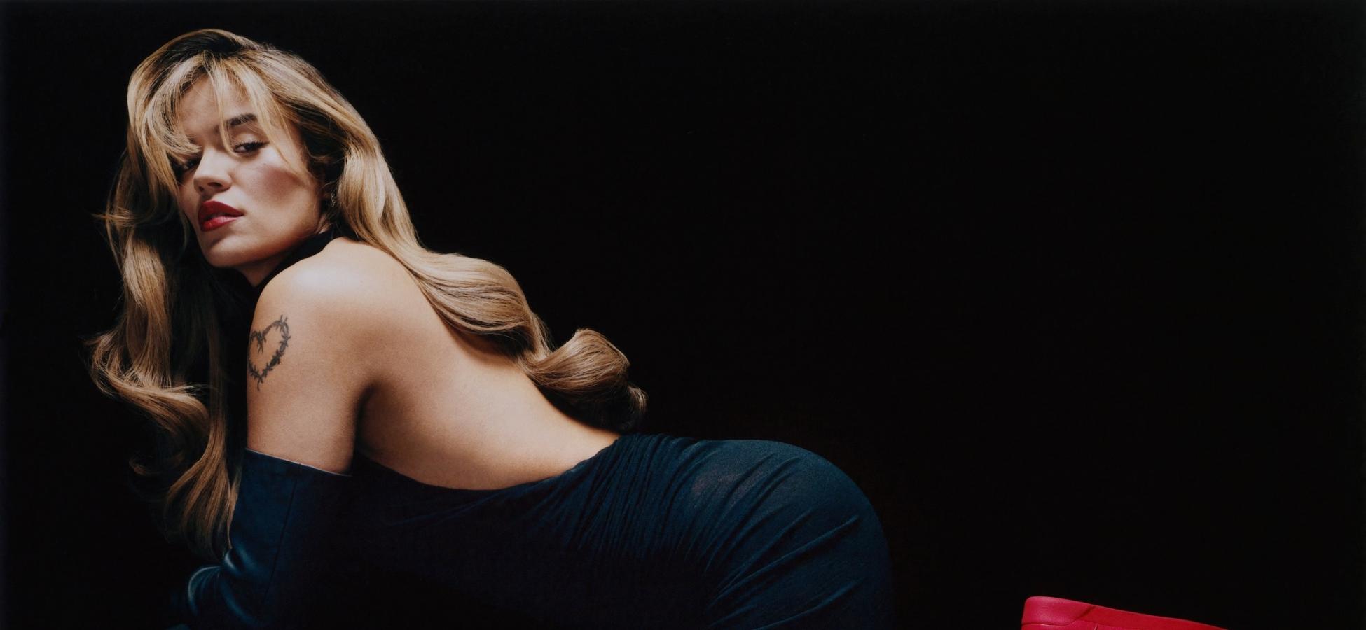 Karol G posing in black