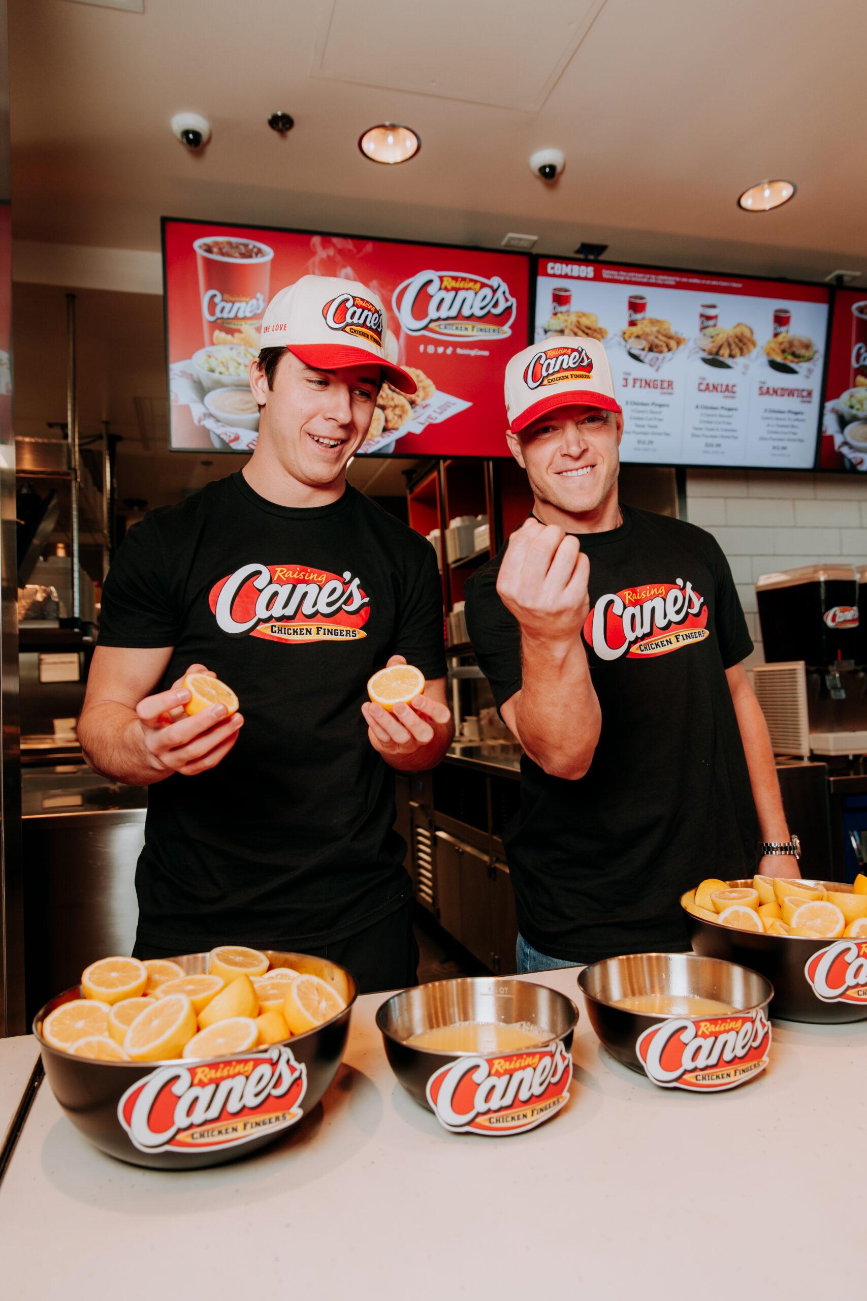Christian and Luke McCaffrey squeezing lemons at Raising Cane's