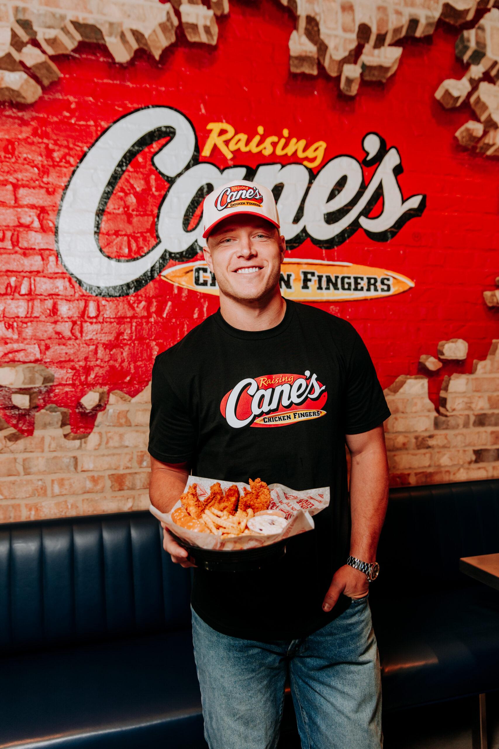 Christian McCaffrey holding Raising Cane's chicken