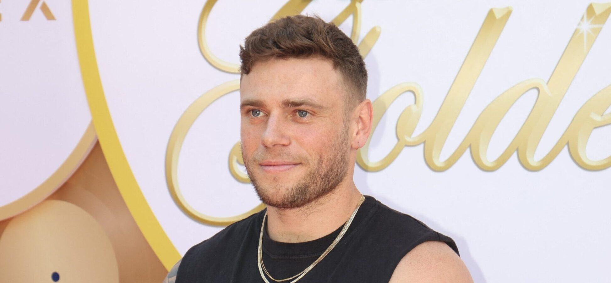 Gus Kenworthy posing on the red carpet.