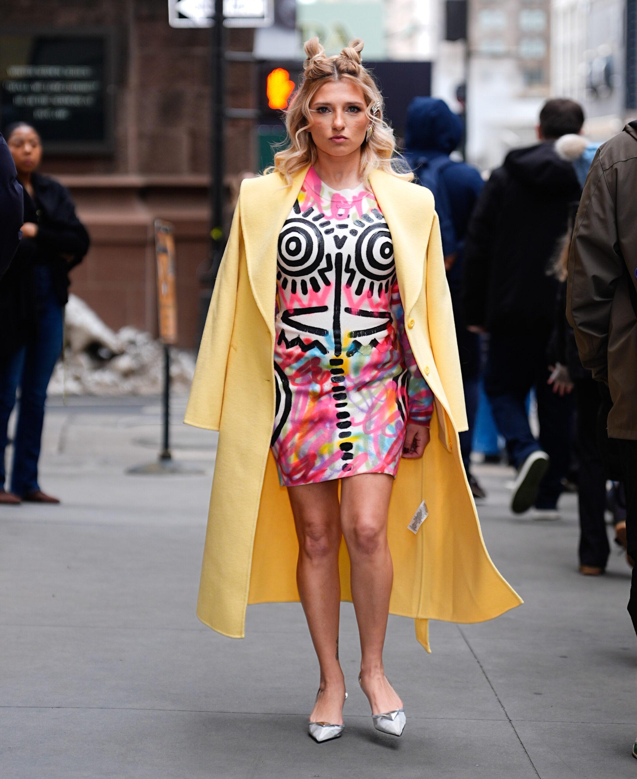 Tina Win wearing colorful dress and yellow jacket