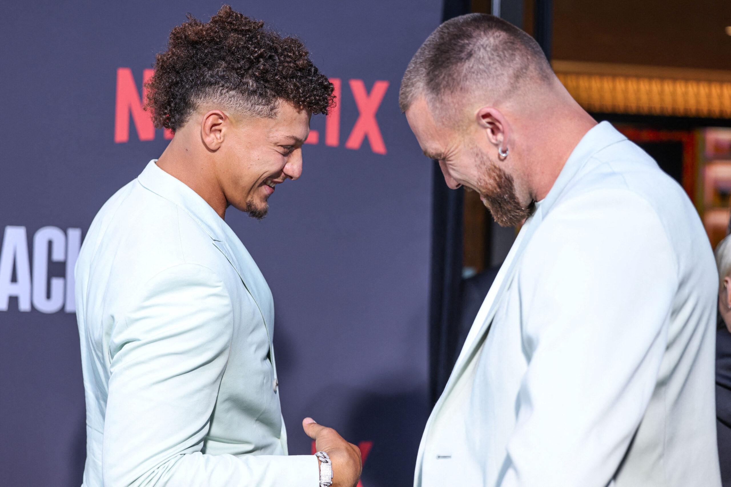 Patrick Mahomes and Travis Kelce posing on the red carpet.