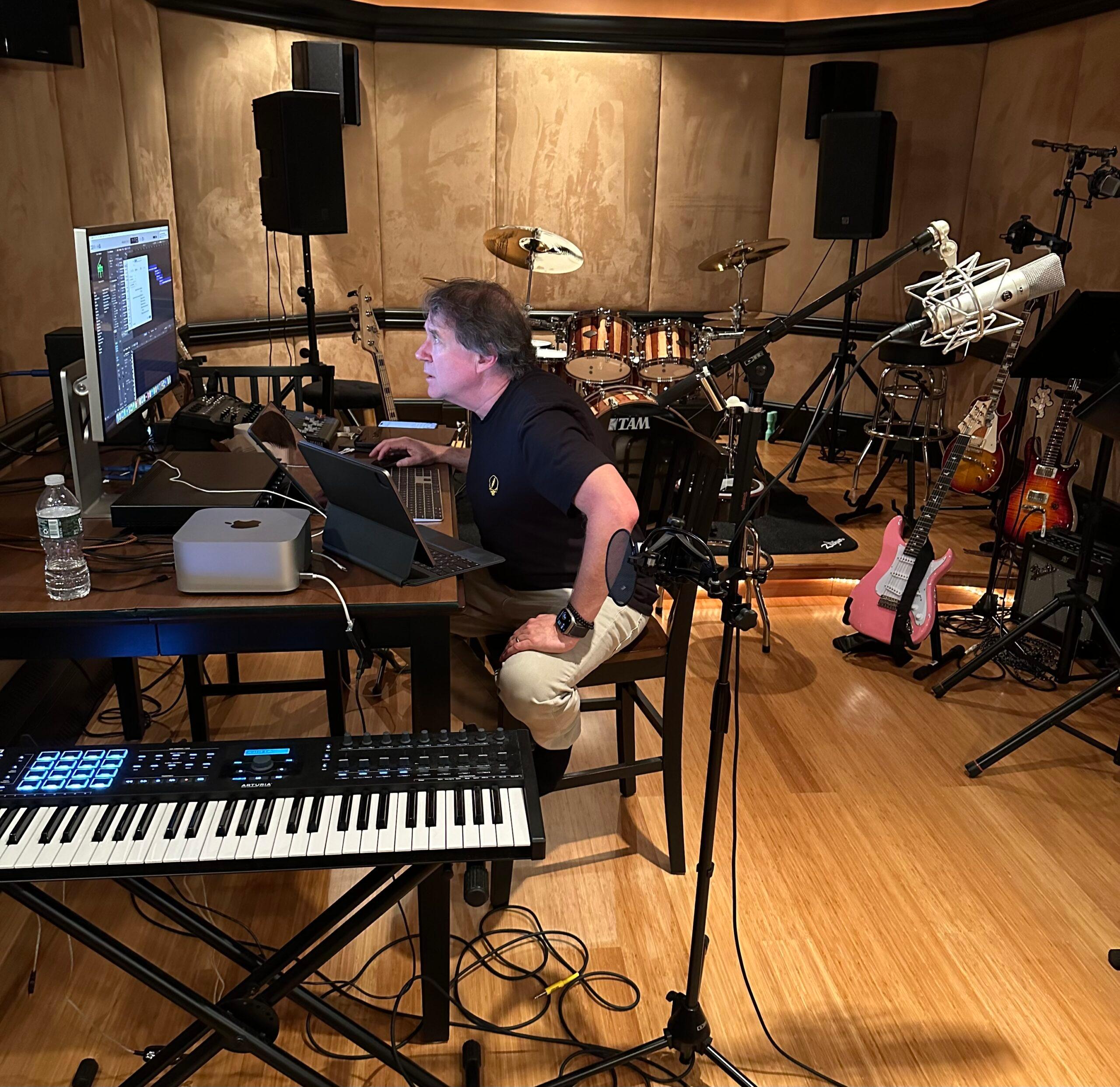 Paul Hennesy sitting in his music studio