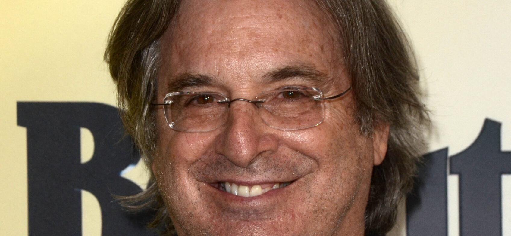 Robert Carradine posing on the red carpet.