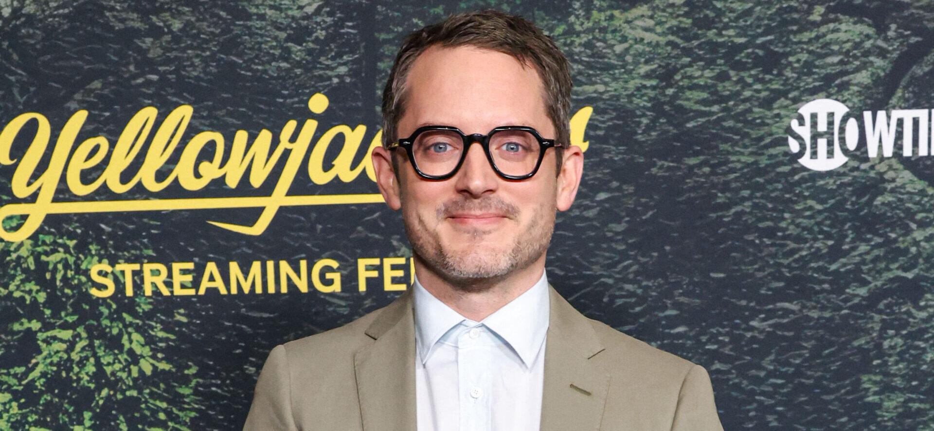 Elijah Wood smiling for photos