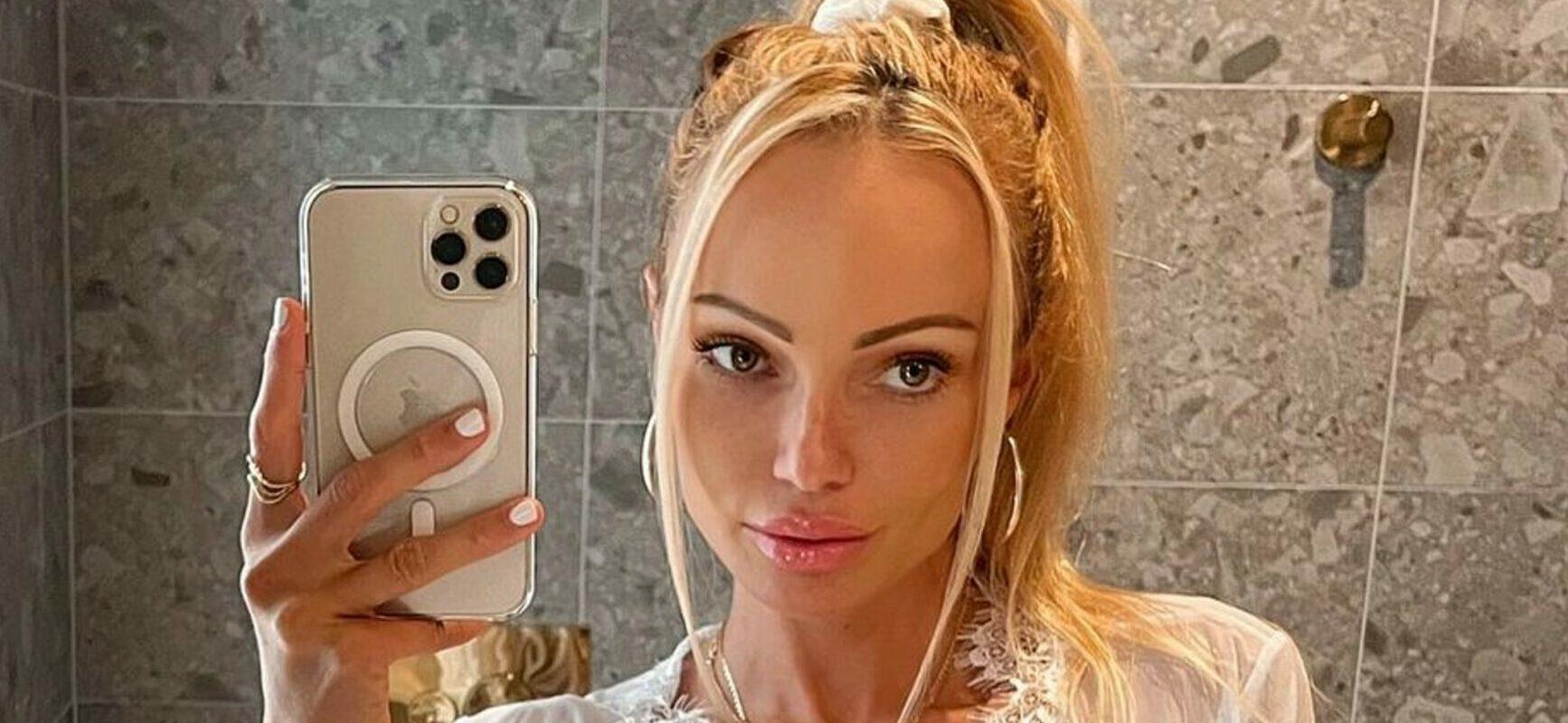 Abby Dowse Lounges In Bed In Her White Lace Teddy