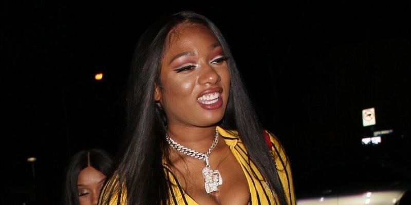Rapper Megan Thee Stallion wears a striped yellow jumpsuit as she parties at the Delilah restaurant