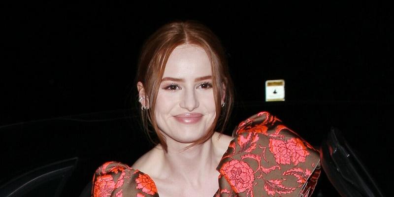 Madelaine Petsch looks stunning in a red dress as she and boyfriend Travis Mills head to Jennifer Klein apos s holiday party
