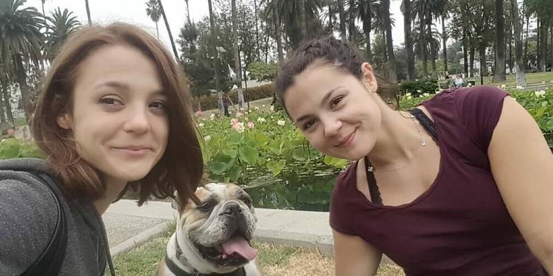 A photo showing Kathryn Prescott sharing a selfie with her sister and her furry friend.