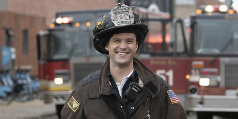 A photo showing Jesse Spencer in his fireman gear with a smile on his face.