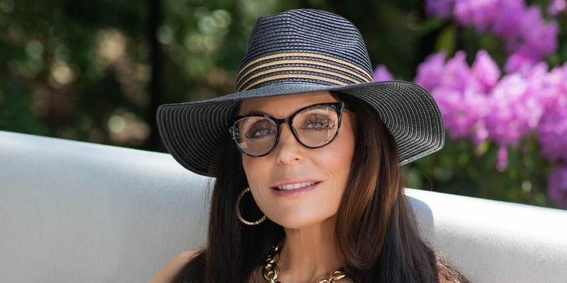 A photo showing Bethenny Frankel wearing a hat and transparent-lend glasses.