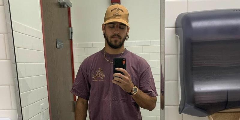 A photo showing Noah Erb taking a mirror selfie in the bathroom