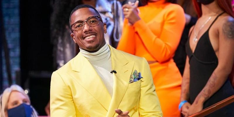 A photo showing Nick Cannon in a yellow suit and matching turtleneck.