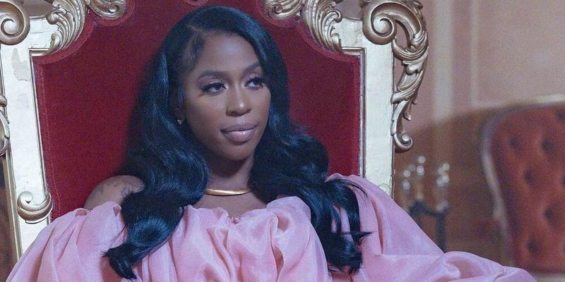 A photo showing Kash Doll in a pink silk puffy design dress.