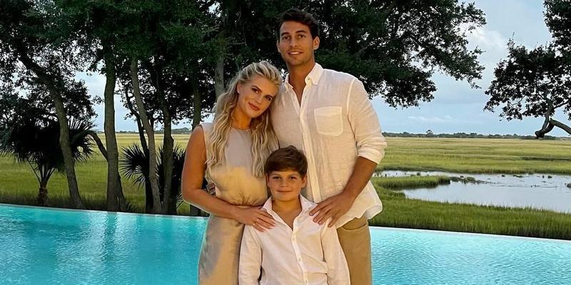 A photo showing Madison LeCroy, her fiancé, Brett, and her son taking a family portrait beside the pool