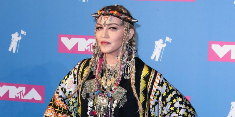 A photo showing Madonna at an event in a traditional outfit.