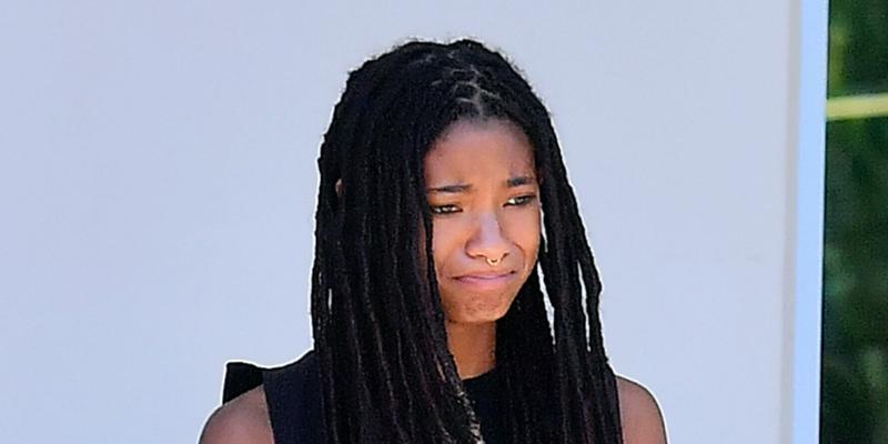 Willow Smith hydrates herself with an energy drink and throws it away into the trash recycle bin after a grocery store visit with her pooch and friends in Calabasas CA