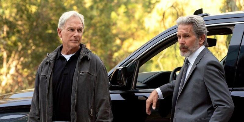 A photo showing Mark Harmon and his colleague standing by a vehicle.