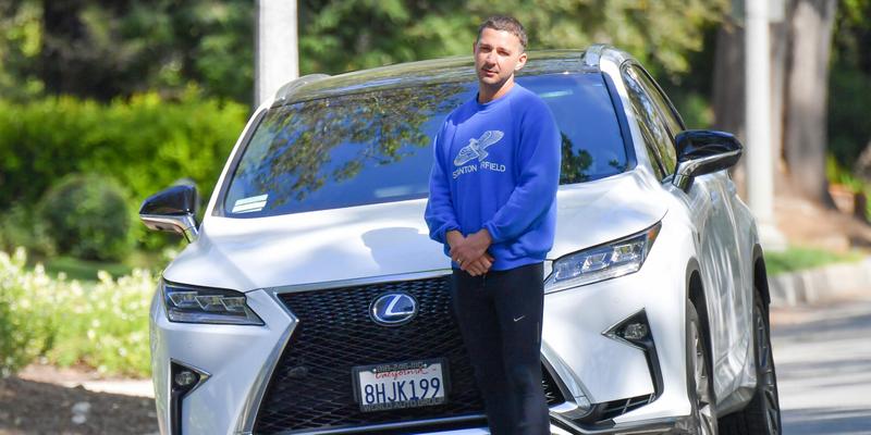Shia LaBeouf blocks in a paparazzi while out for a walk in his Pasadena neighborhood