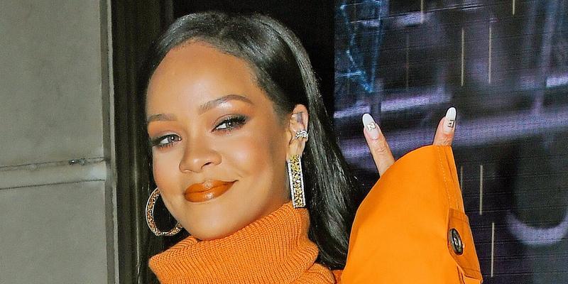 Rihanna stops by Fenty pop-up in an all orange outfit