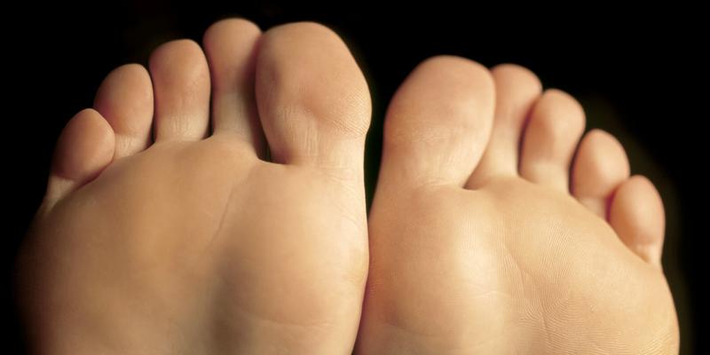 Shallow depth-of-field image of the bottom of a females feet.