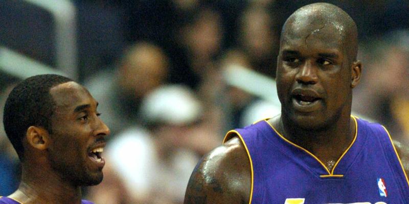 Kobe Bryant and Shaquille O'Neal talk during a timeout against Washington on Saturday, February 28, 2004