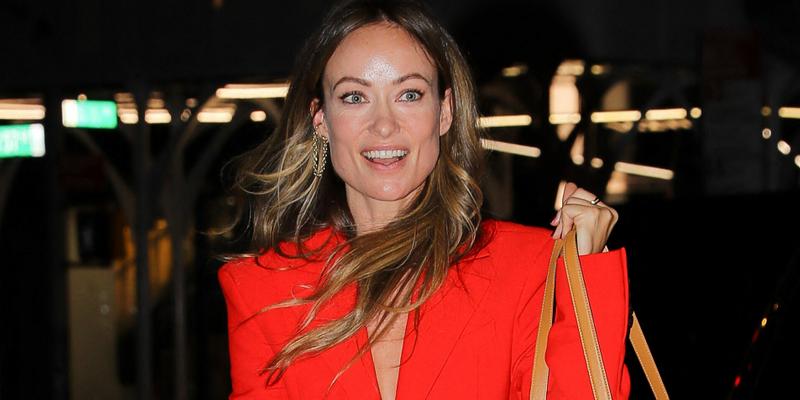Olivia Wilde is all smiles while wearing a Red Suit as arriving to her hotel in New York City