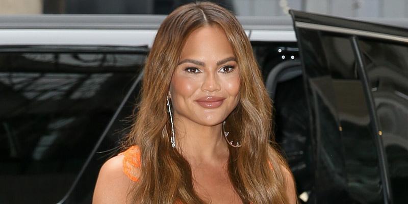 Chrissy Teigen wears a mini dress while arriving back at her hotel in New York City