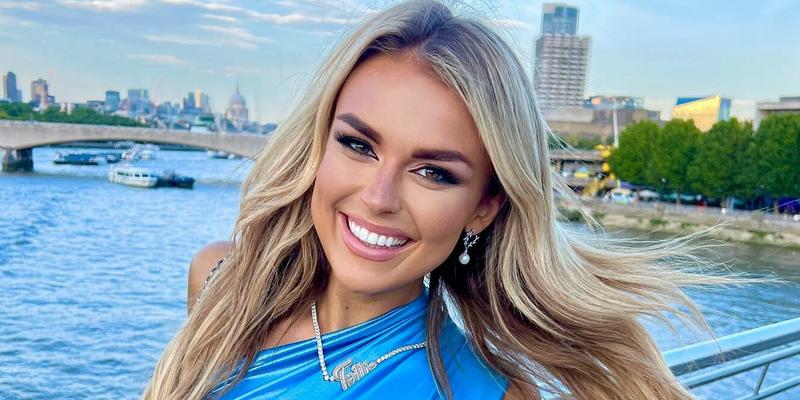 Tallia Storm smiles in a blue dress