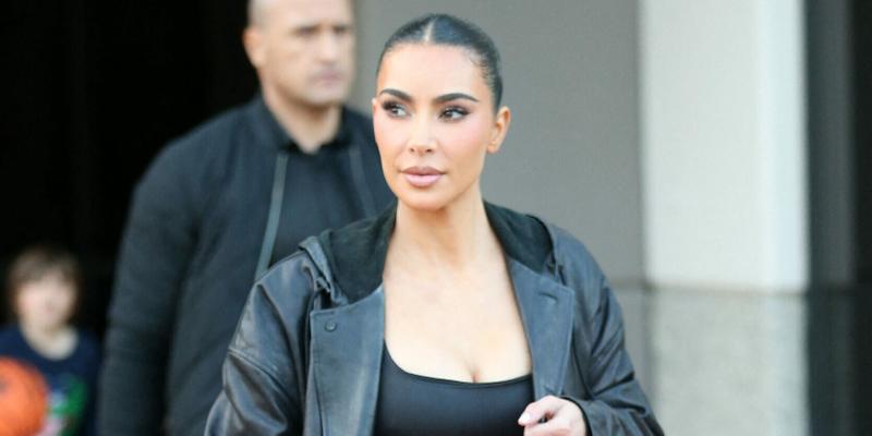 Kim Kardashian wears a long black leather jacket as she is seen leaving a basketball game in Thousand Oaks Ca