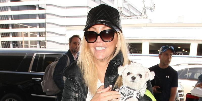 Heather Locklear looks casual and dressed down as she hold on tight to her dog as she jets out of LAX