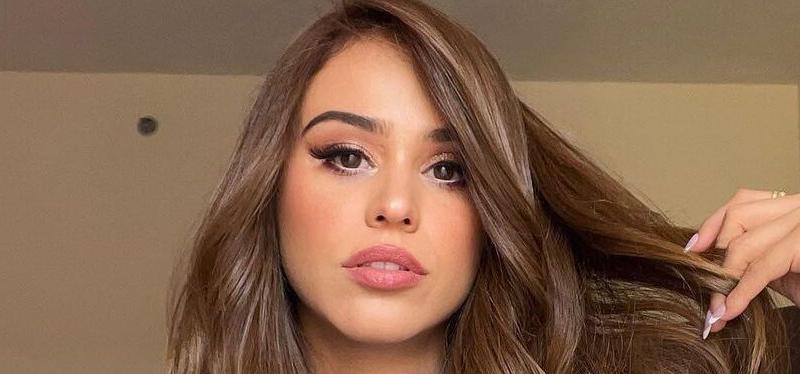 Yanet Garcia poses for the camera in a white bath robe.