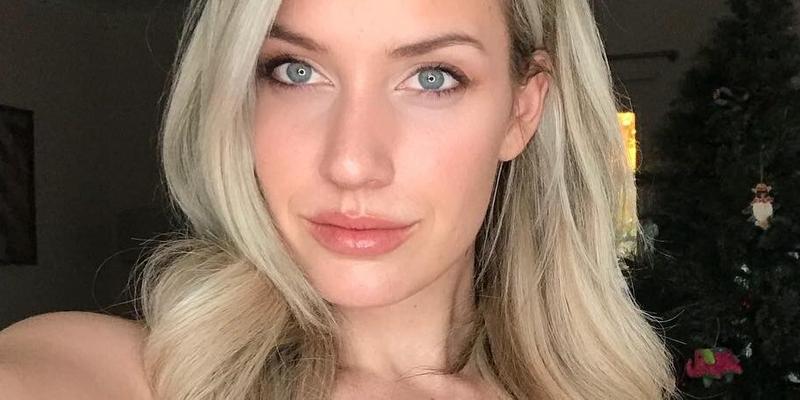Paige Spiranac takes a selfie in a low-cut yellow top.