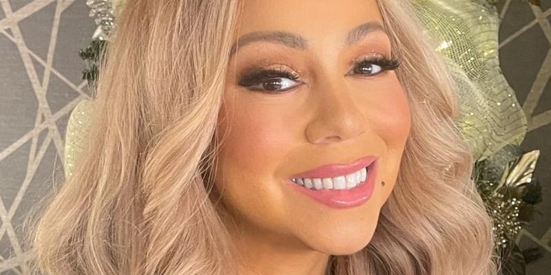 Mariah Carey poses smiling