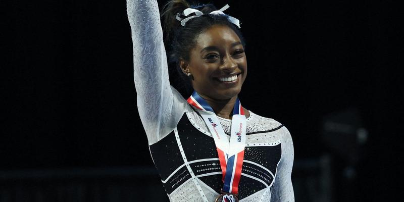 Simone Biles smiles as she takes home Olympic medal