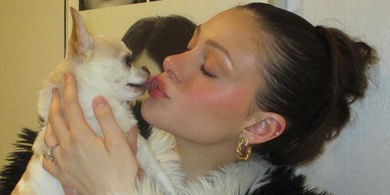 A photo of Nicola Peltz kissing her dog Nala