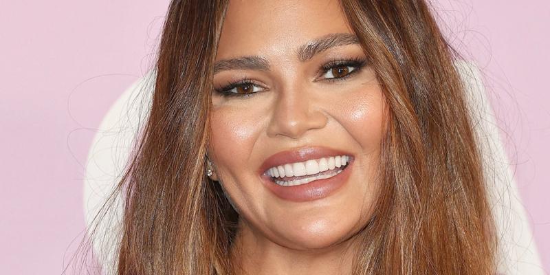 Chrissy Teigen smiles at an event