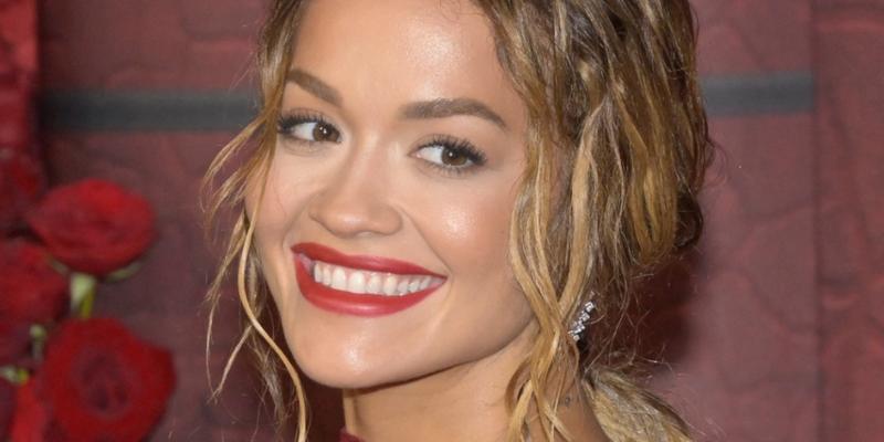 Rita Ora smiles at an event