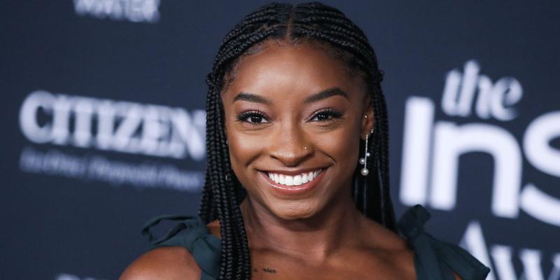 Simone Biles wearing an Aliette dress, Christian Louboutin shoes, and Matteo jewelry while carrying a Judith Leiber bag arrives at the 6th Annual InStyle Awards 2021