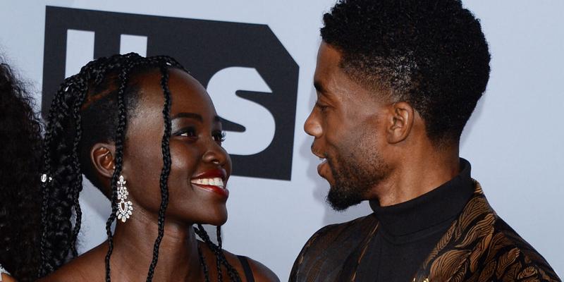 Lupita Nyong’o and Chadwick Boseman smiling