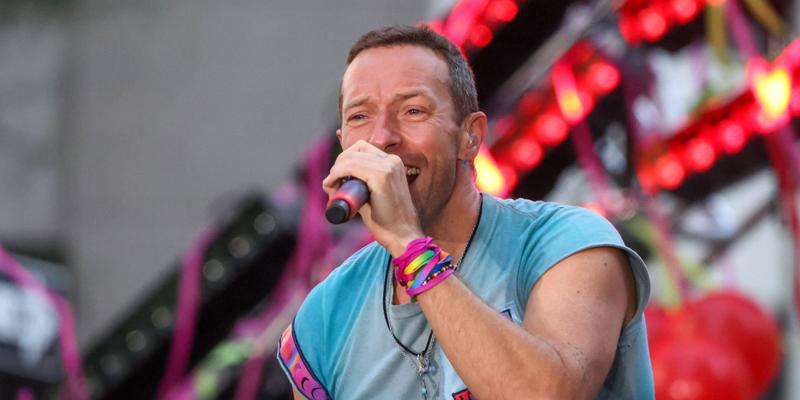 Vocalist Chris Martin along with his band Coldplay during a performance on a television show at Rockefeller Plaza in New York City