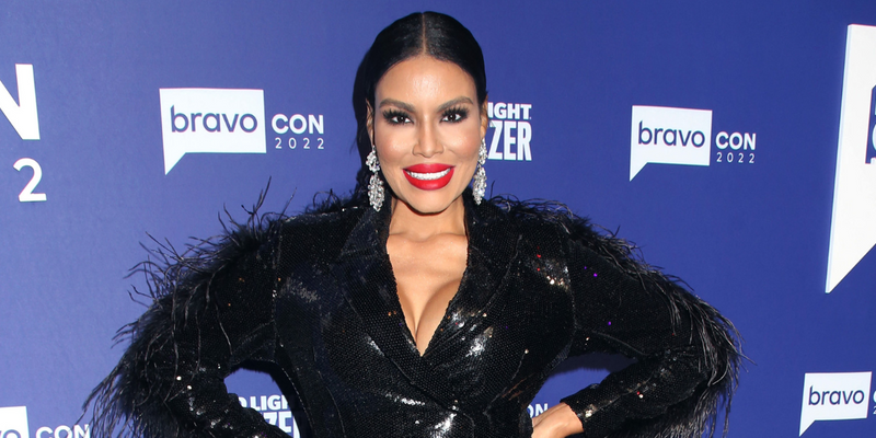 Mia Thornton posing in a black dress on the red carpet.