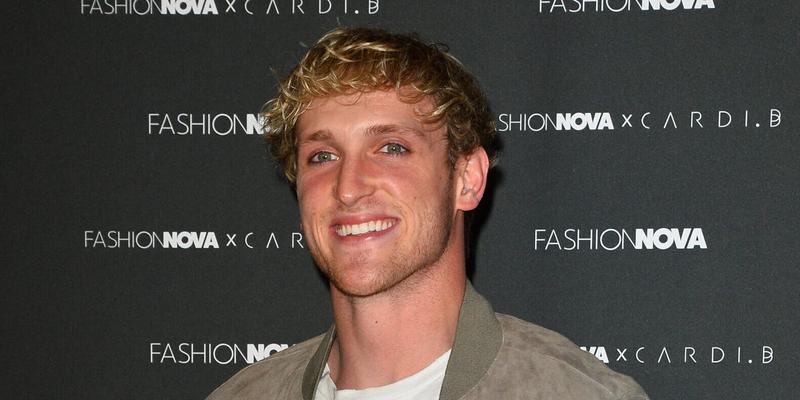 Logan Paul smiling in a green jack on the red carpet.