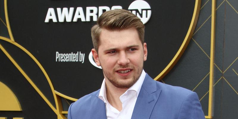 Luka Doncic smiling on the red carpet.