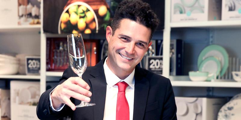 Wells Adams holding champange glass in JCPenney