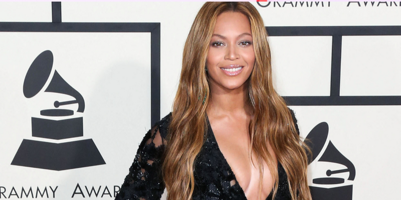 Beyoncé posing in a black dress during a previous Grammys red carpet event.