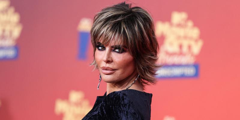 Lisa Rinna posing in a black dress during the MTV Movie Awards.