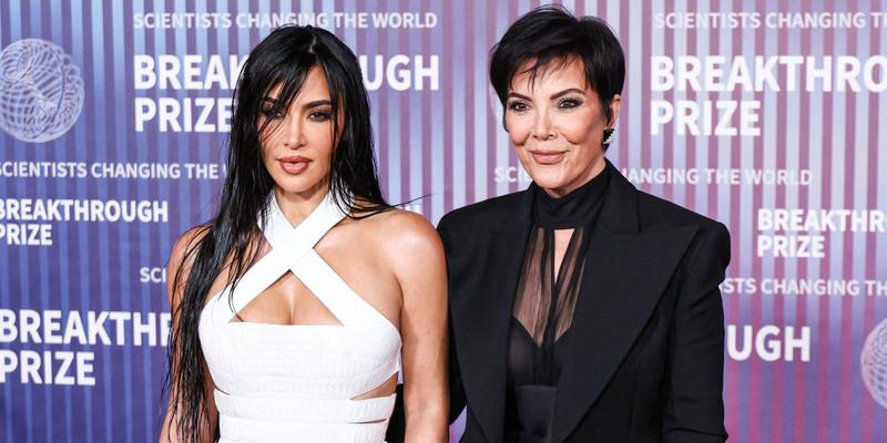 Kim Kardashian and Kris Jenner posing on the red carpet.