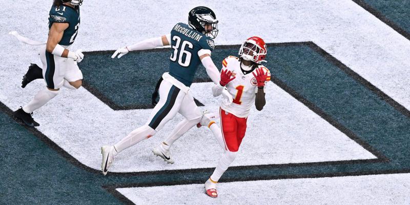 Xavier Worthy catching a football during an NFL game.